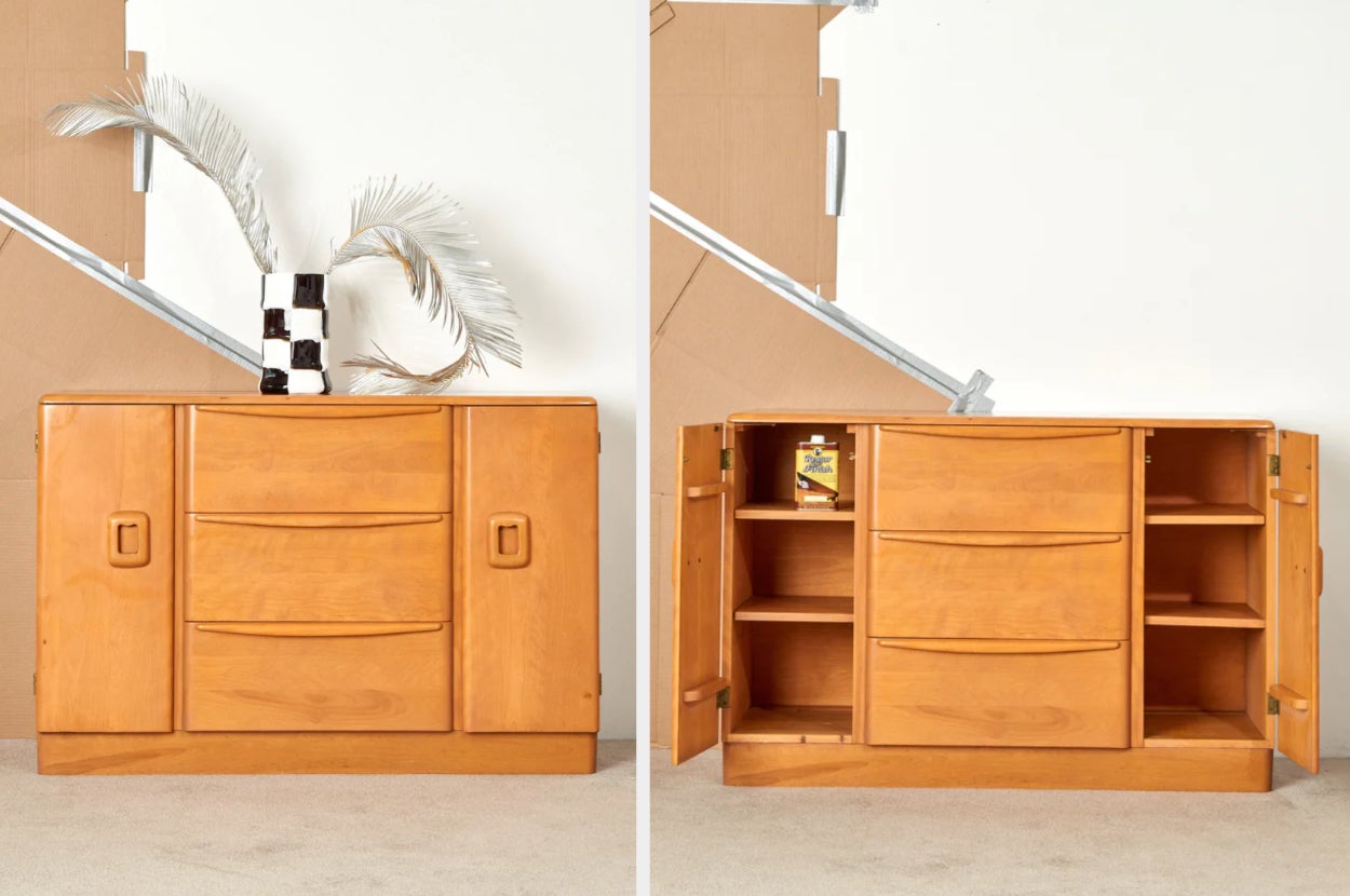Brown wooden accent cabinet with three center drawer and two side doors, interior shot of product with side doors open