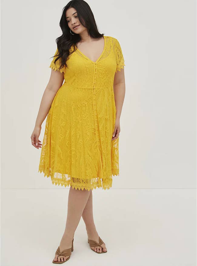 model wearing the lacy yellow skater dress