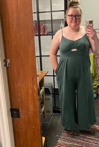 reviewer wearing the green jumpsuit