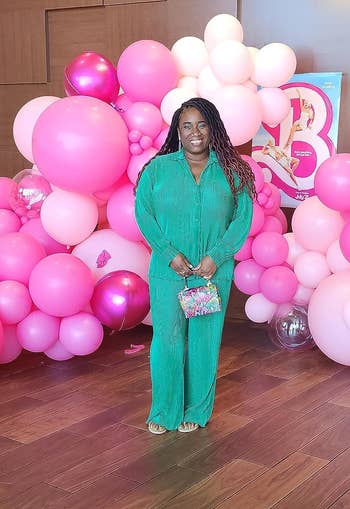reviewer wearing greenish  set