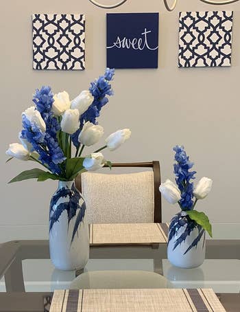 Reviewer image of products on top of a glass table with white and blue flowers inside it