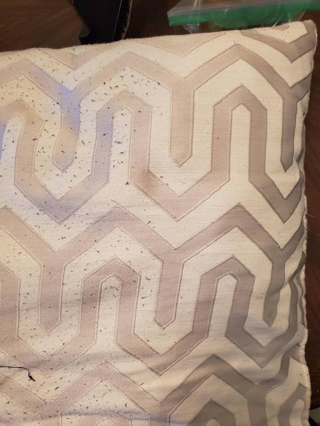 Decorative pillow with a textured zigzag pattern and half of it is pilling and the other half has been shaved so there are no pills