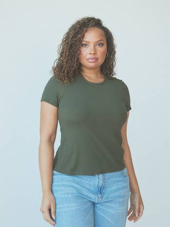 Model in a casual green T-shirt and blue jeans