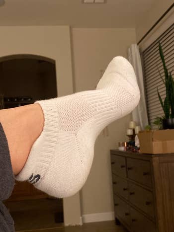 a reviewer wearing white socks