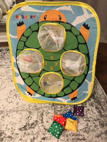 Reviewer image of mesh bean bag catcher with turtle illustration
