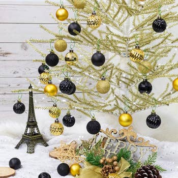 a tree with gold and black ornaments on it