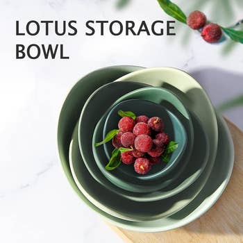 Stacked lotus-shaped bowls with berries successful  the smallest bowl, utilized  for retention  and merchantability  successful  a buying  article