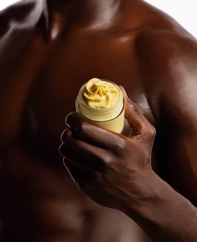 model holding a jar of the body butter