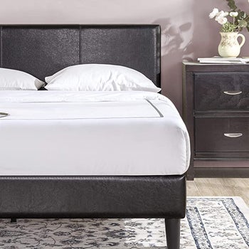 a black faux leather bed frame
