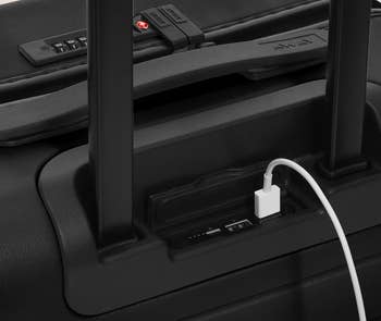 A closeup of the USB charging port on the suitcase