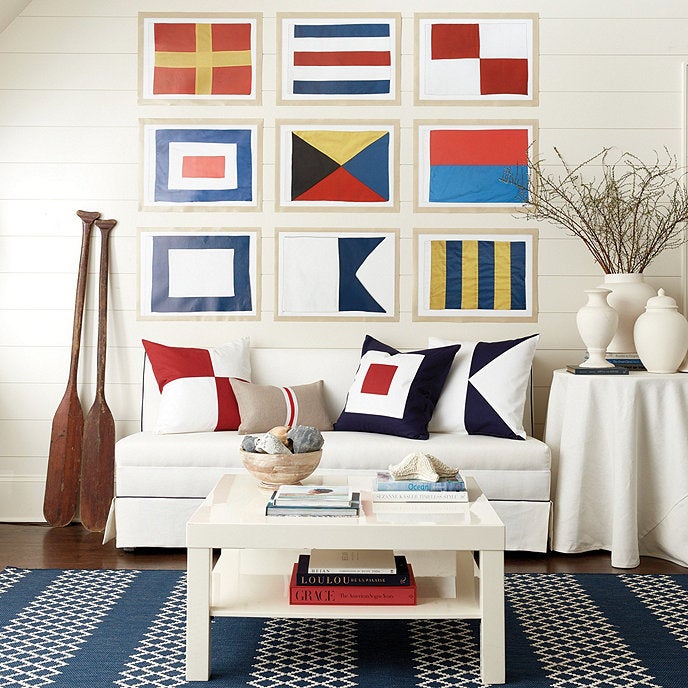 a gallery wall with nine of the nautical flags