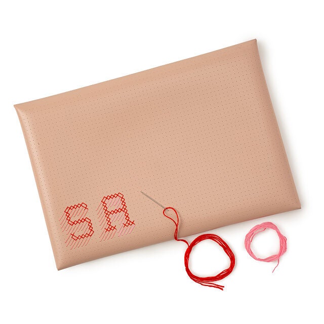 the laptop cover in pink, with pink and red thread
