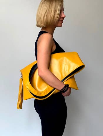 A model wearing the purse as a clutch