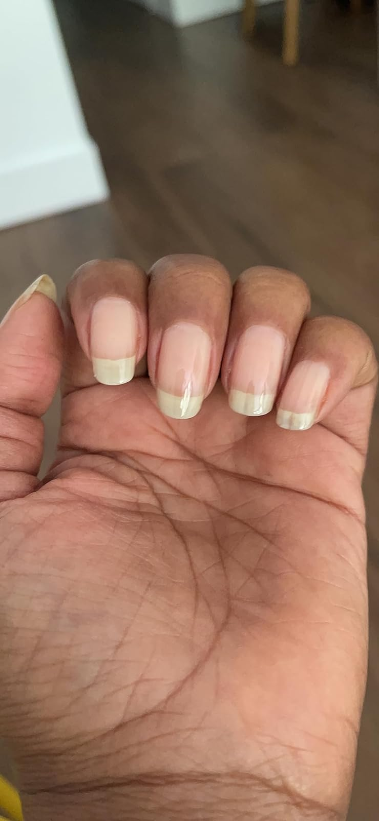 Close-up of a person’s hand showing natural, well-maintained fingernails.