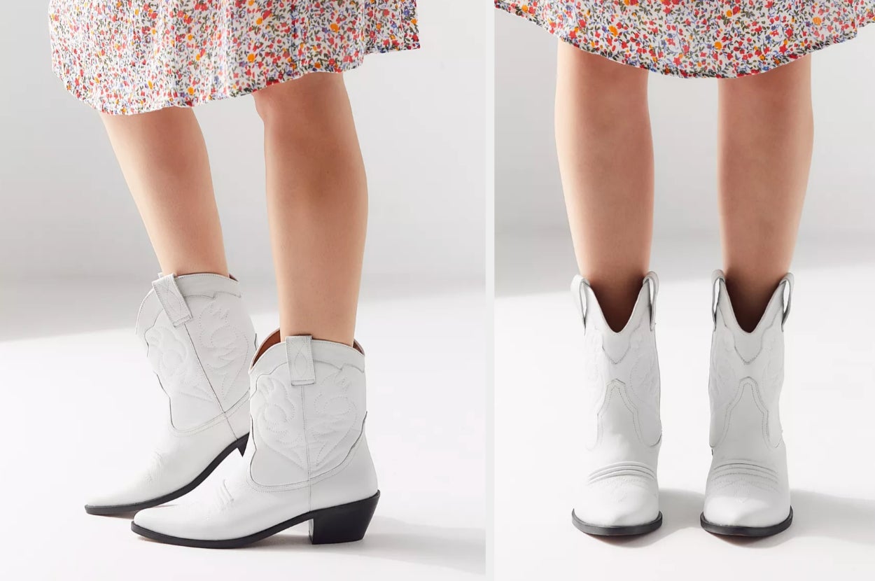 Model wearing ankle white cowboy boots with rounded tops on a white background