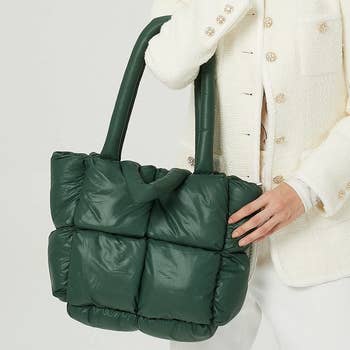 model holding the green padded tote