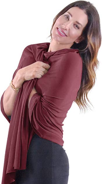 model wearing the burgundy shawl as a wrap