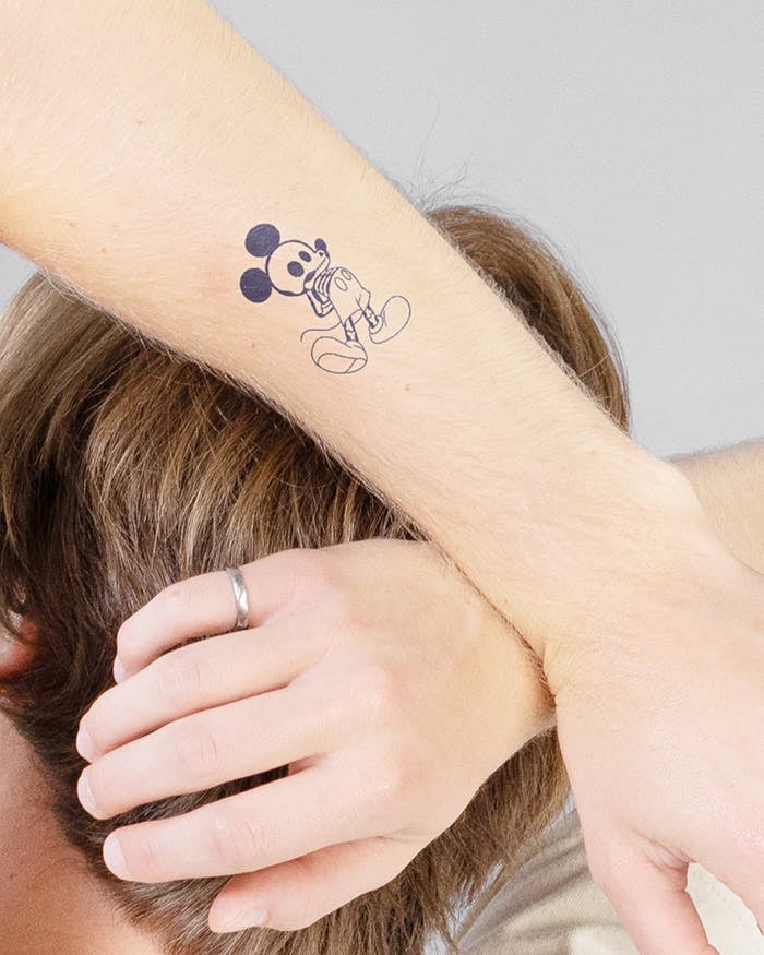 a model with an outline of mickey getting an xray as a tattoo