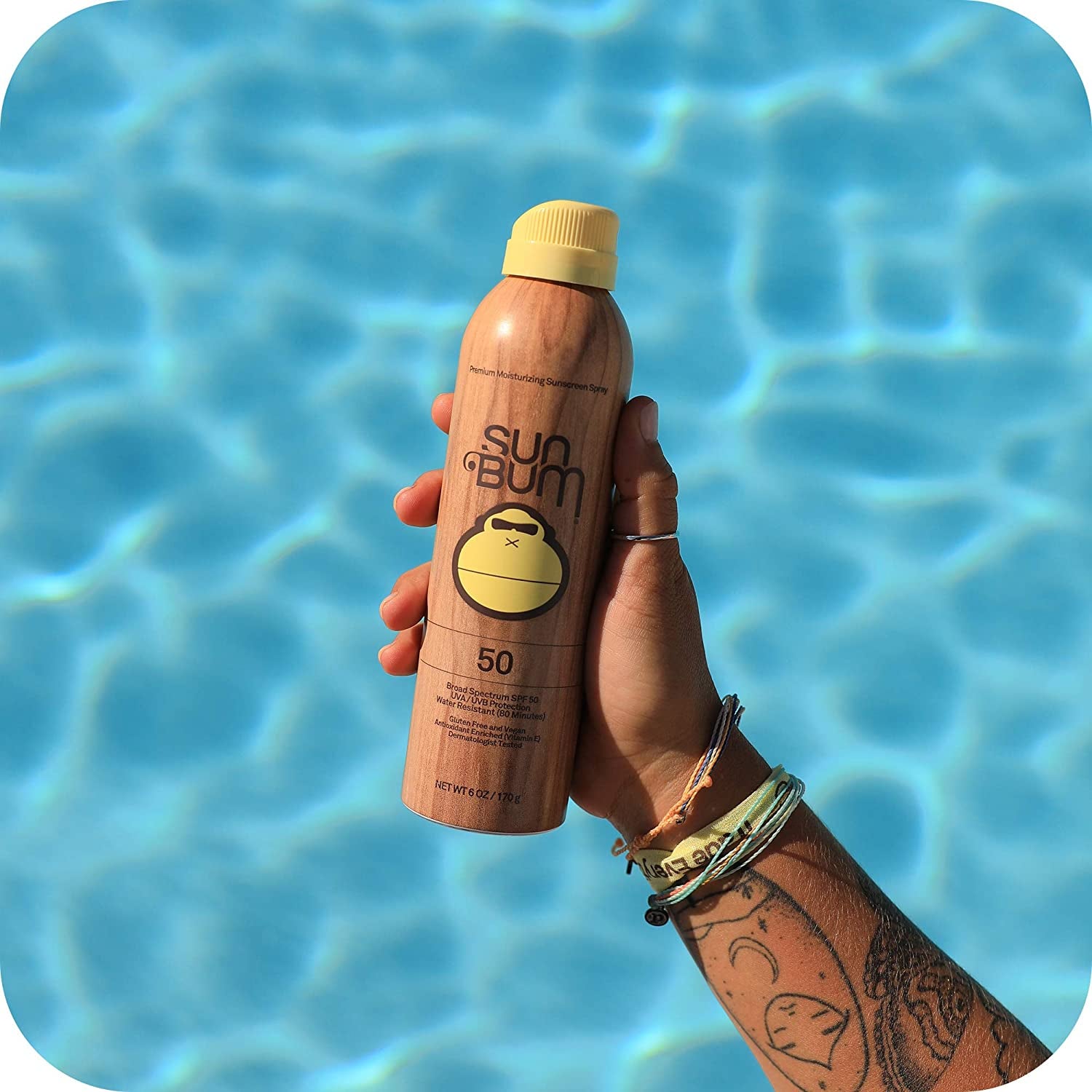 a hand holding the sunscreen