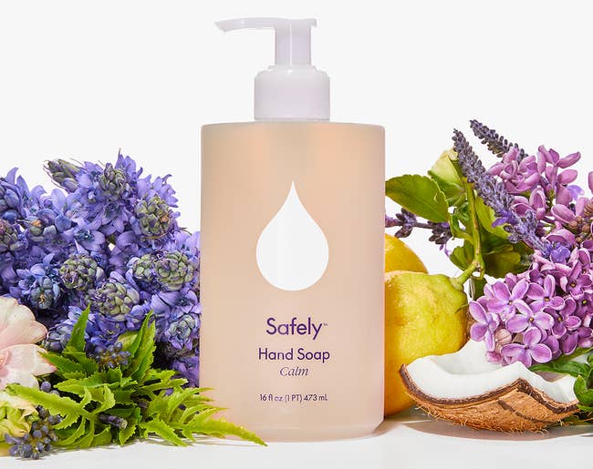 Image of the beige Safely hand soap next to lemons, coconut shells, and flowers