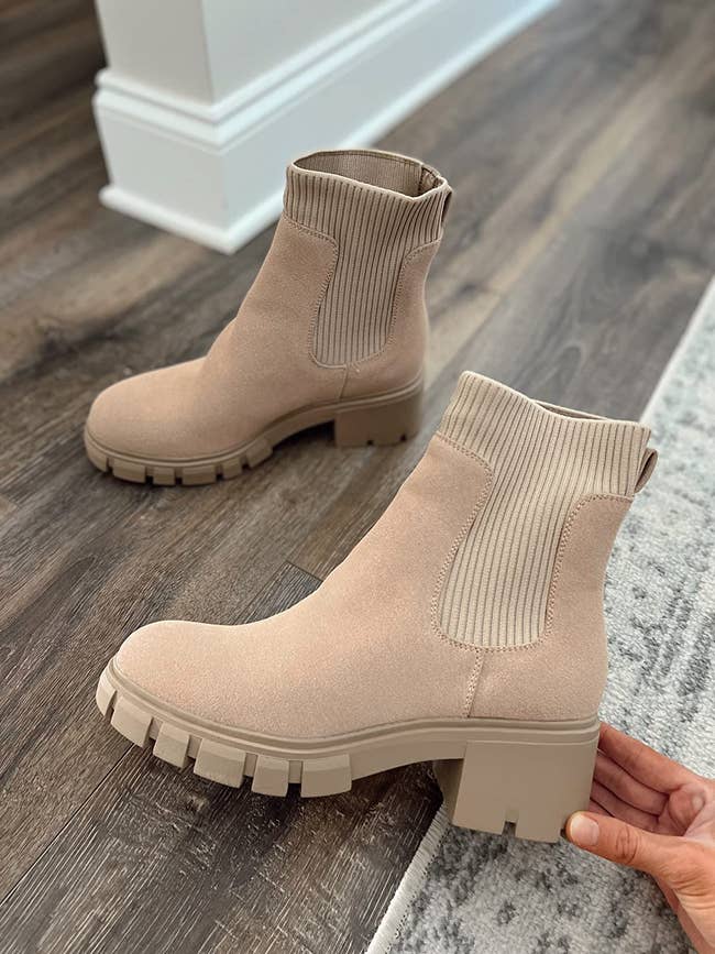 reviewer showing tan knit-top Chelsea boots