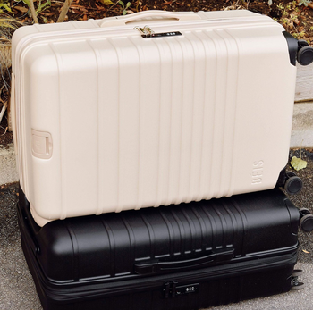 the Béis white and black 29-inch suitcases stacked on top of each other