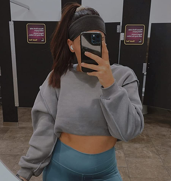 another reviewer wearing the grey sweatshirt