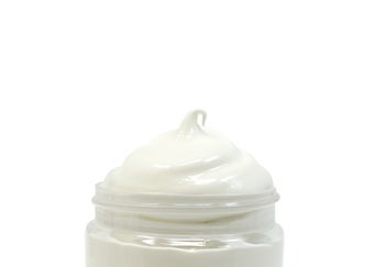 Tub of lubricant showing white creamy consistency