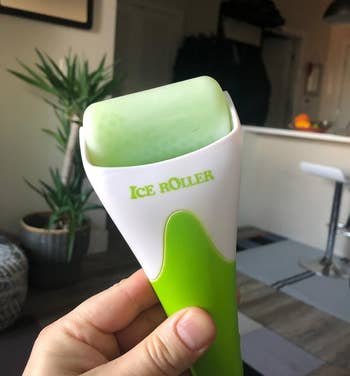 Hand holding an ice roller skincare tool