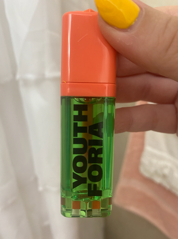 The green and orange bottle of blush 