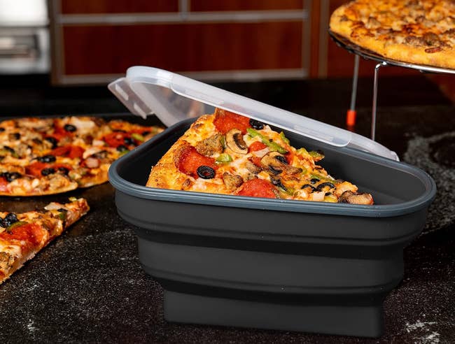 Pizza storage container with a slice, advertises microwave and storage for five slices