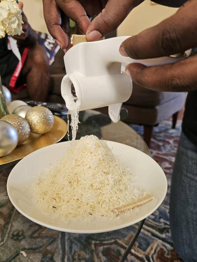 Cheese being grated implicit a sheet by a reviewer