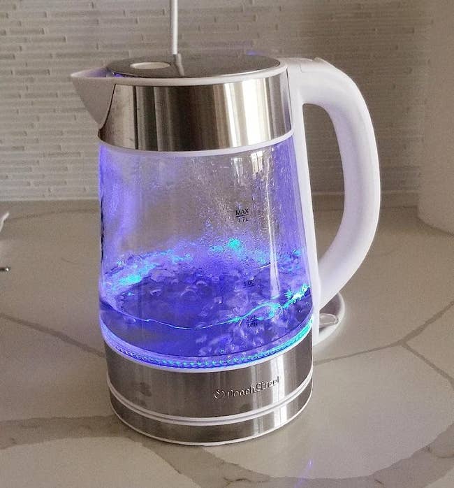The reviewer's electric kettle boiling water with blue LED light on