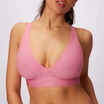 Model wearing pink plunge mesh bralette