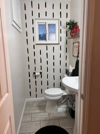 reviewer image of a bathroom with line decals on a wall