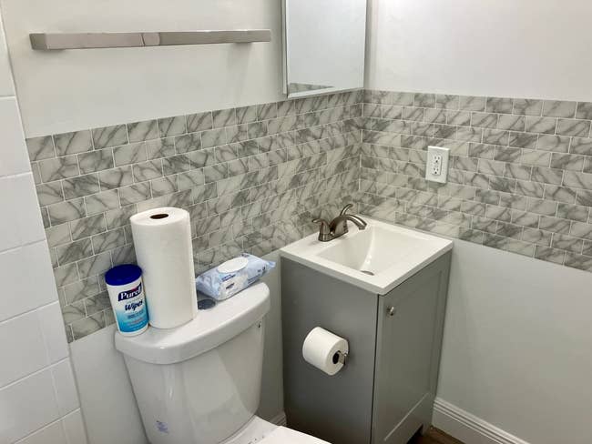 a reviewer's bathroom with the faux marble tiles