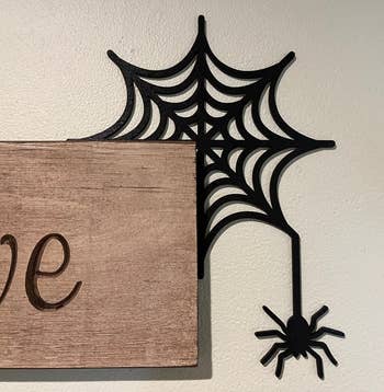 the spider web and spider corner sign hugging the corner of another sign