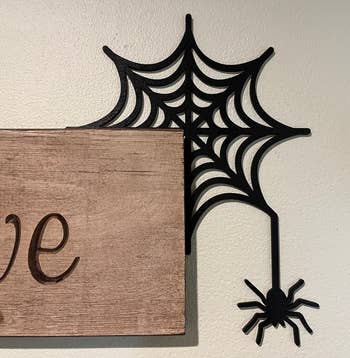 the spider web and spider corner sign hugging the corner of another sign