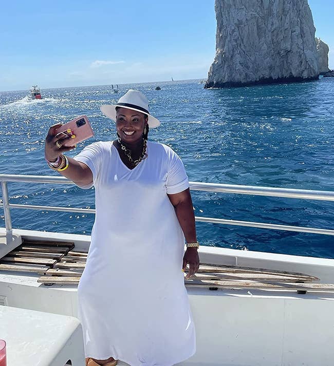 reviewer photo taking a selfie on a boat, wearing white maxi dress