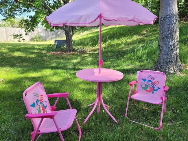 Kids' outdoor patio acceptable   with mermaid-themed chairs and a array  featuring an umbrella