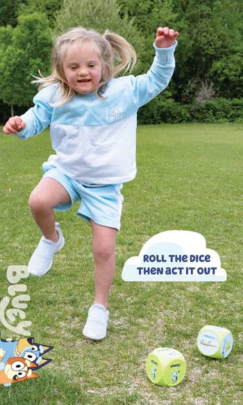 child is joyfully playing in a grassy field, wearing a sweatshirt and shorts. Two large dice prompt actions