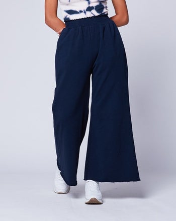 model bottom half wearing wide-leg navy blue palazzo pants