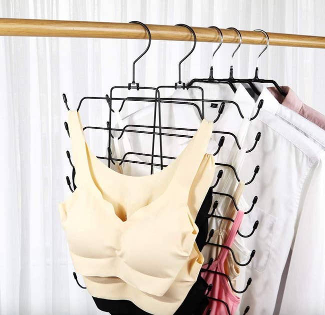 hanger in closet with bras on one side and tank tops on the other