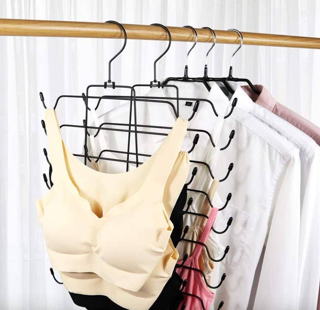 hanger in closet with bras on one side and tank tops on the other