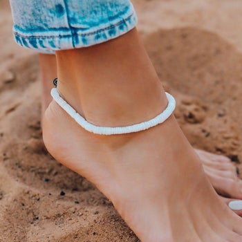 Model wearing white shell anklet