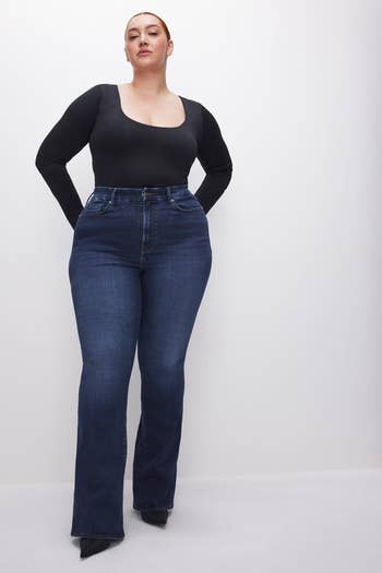 a model wearing the dark denim bootcut jeans