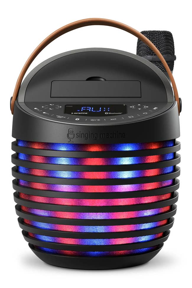 Portable karaoke machine with handle and colorful LED lights, featuring a microphone. Ideal for home entertainment or gift shopping