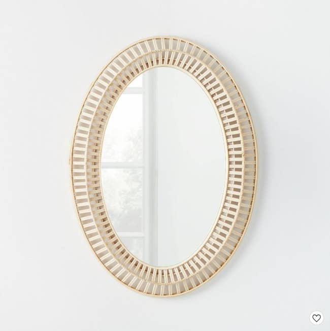 A woven oval wall mirror