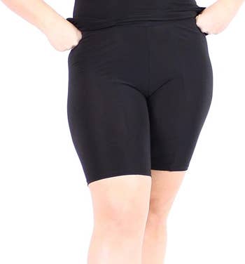 A person modeling black anti-chafing shorts