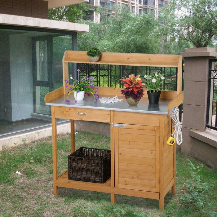 light wood counter-height bench with steel counter and one raised shelf for plants